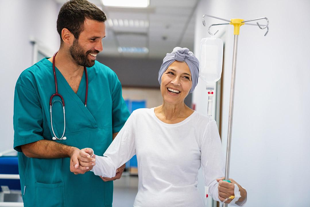 A cancer patient being assisted by a healthcare professional