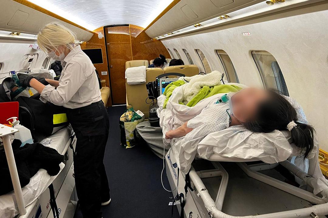 A patient onboard an air ambulance with a nurse