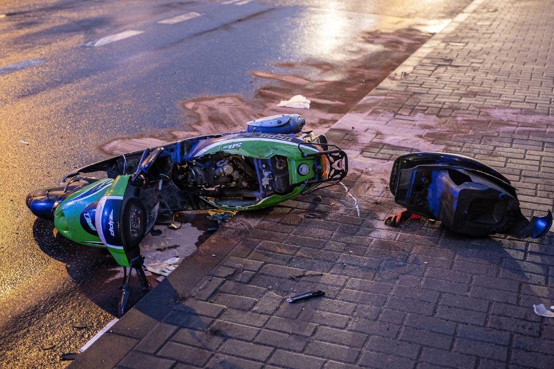 A scooter on the side of the road following an accident